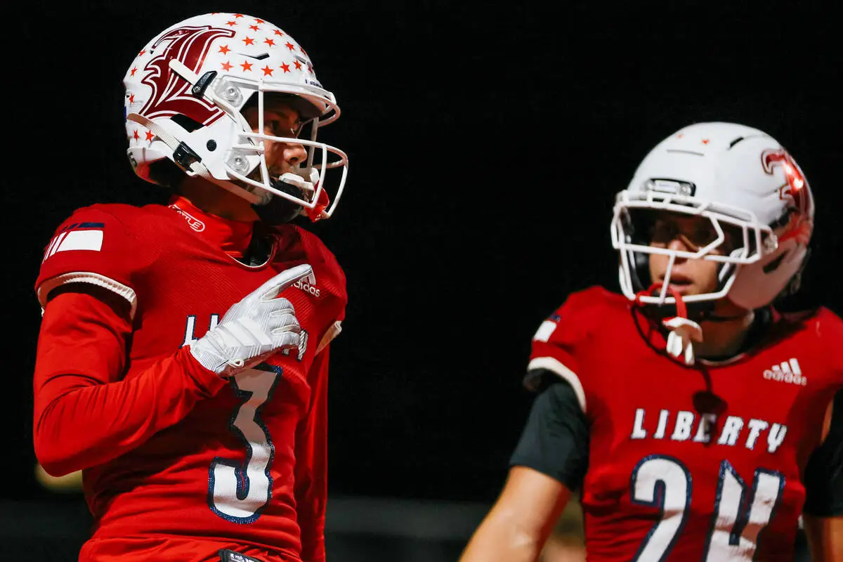 Liberty quarterback Selby Griego (3), left, and Liberty running back Anthony Alberro (24) celeb ...