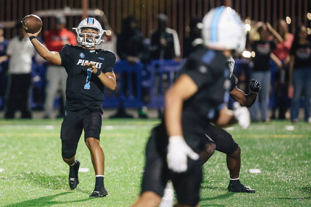 Sloan Canyon quarterback Cade Hoshino (1) throws the ball to a teammate during a high school fo ...