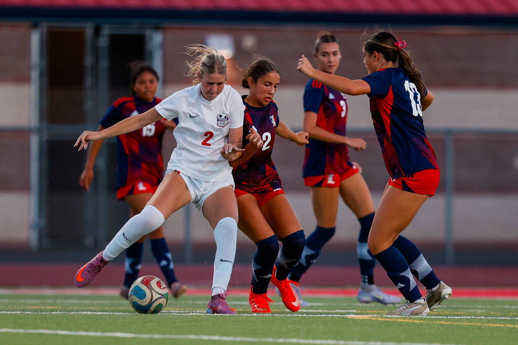 Coronado Cougars senior Emily McKinney (2) attempts to advance the ball towards the goal as Lib ...