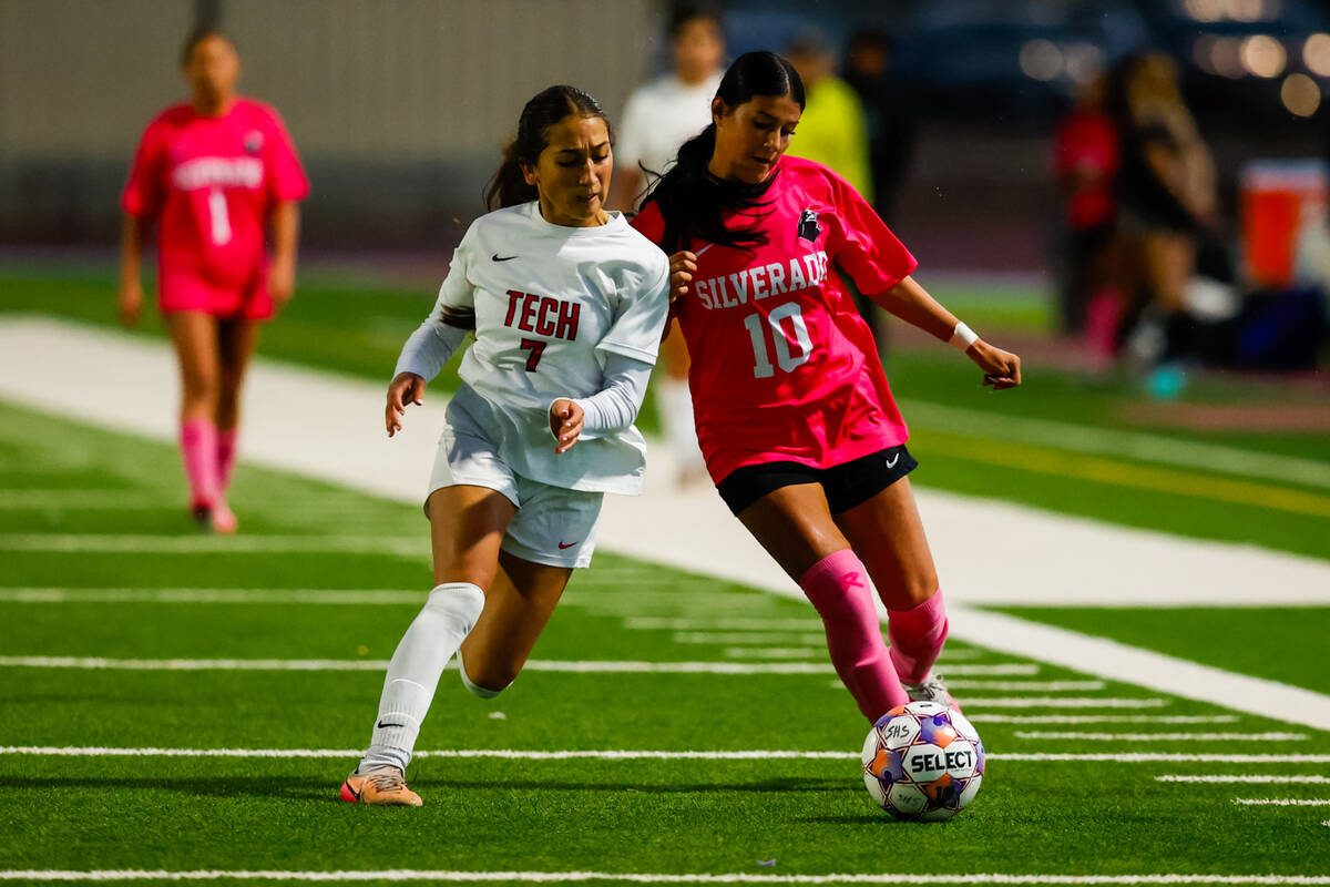 Silverado senior Makenze Oliver (10) and SECTA senior Olivia Mowery (7) both go for a free ball ...