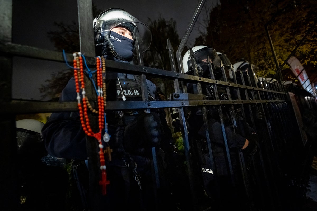 Polish president turns back from foreign trip as police and protesters clash over ‘constitutional crisis’