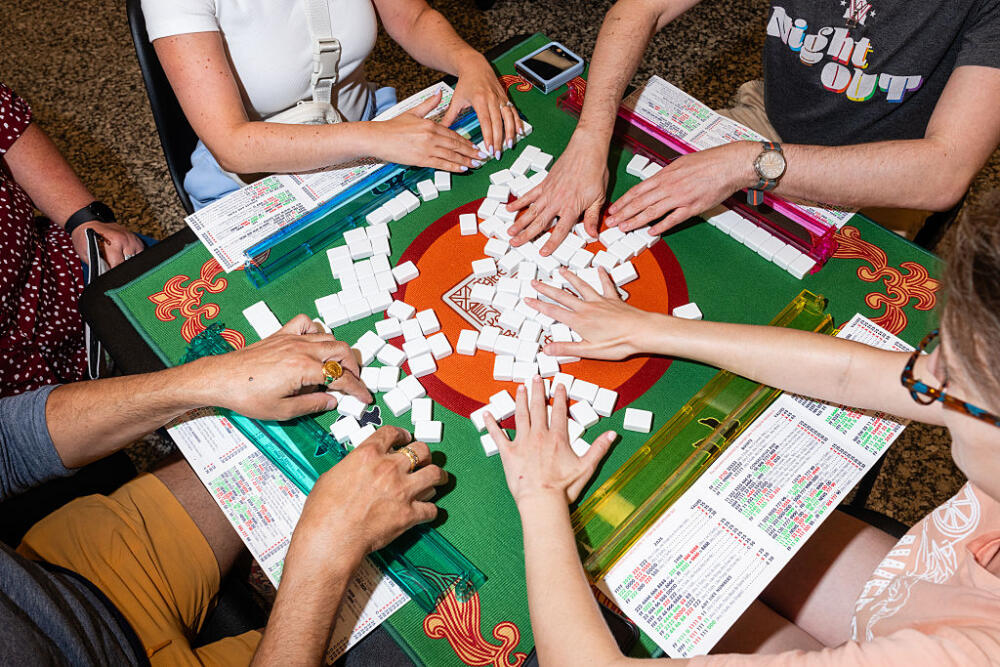 People play mahjong during "Mahjong Night" at the Martin Luther King Jr. Library in Washington, D.C. on Tuesday, July 22, 2025. (Eric Lee/For The Washington Post via Getty Images)