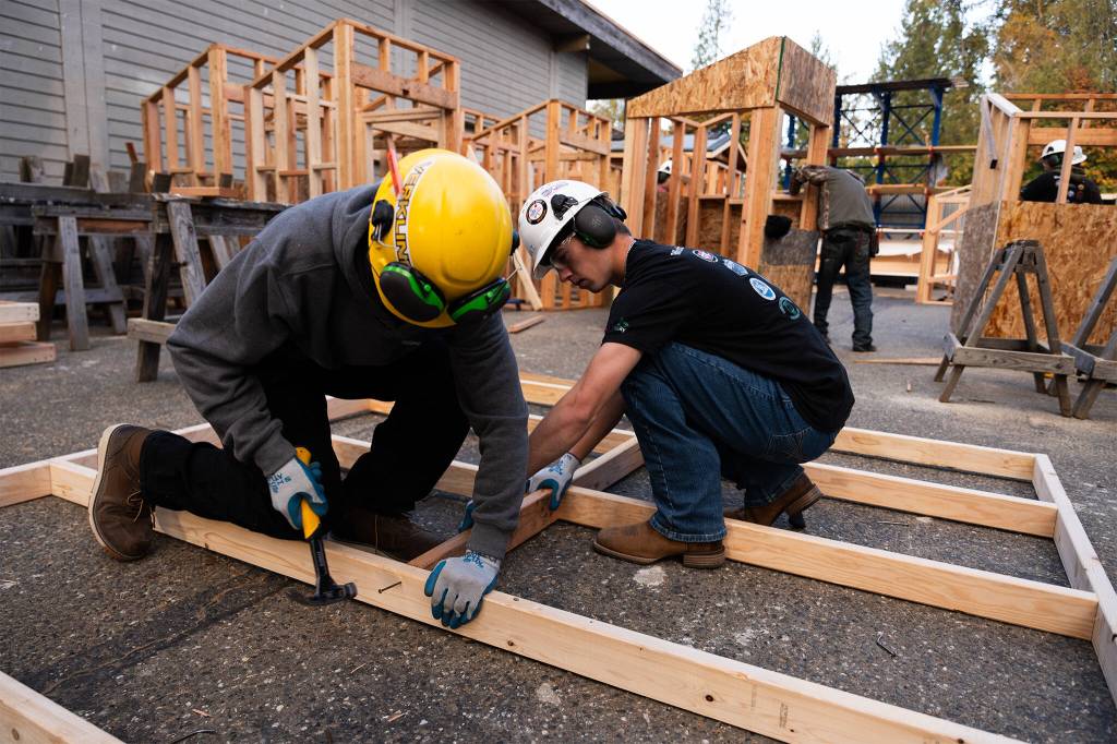 Blake Dziudek, left, and Nathan Titterington, right, work on a project at the Regional Apprenticeship Pathways program on Friday, Oct. 23, 2026, in Marysville, Washington. (Will Geschke / The Herald)