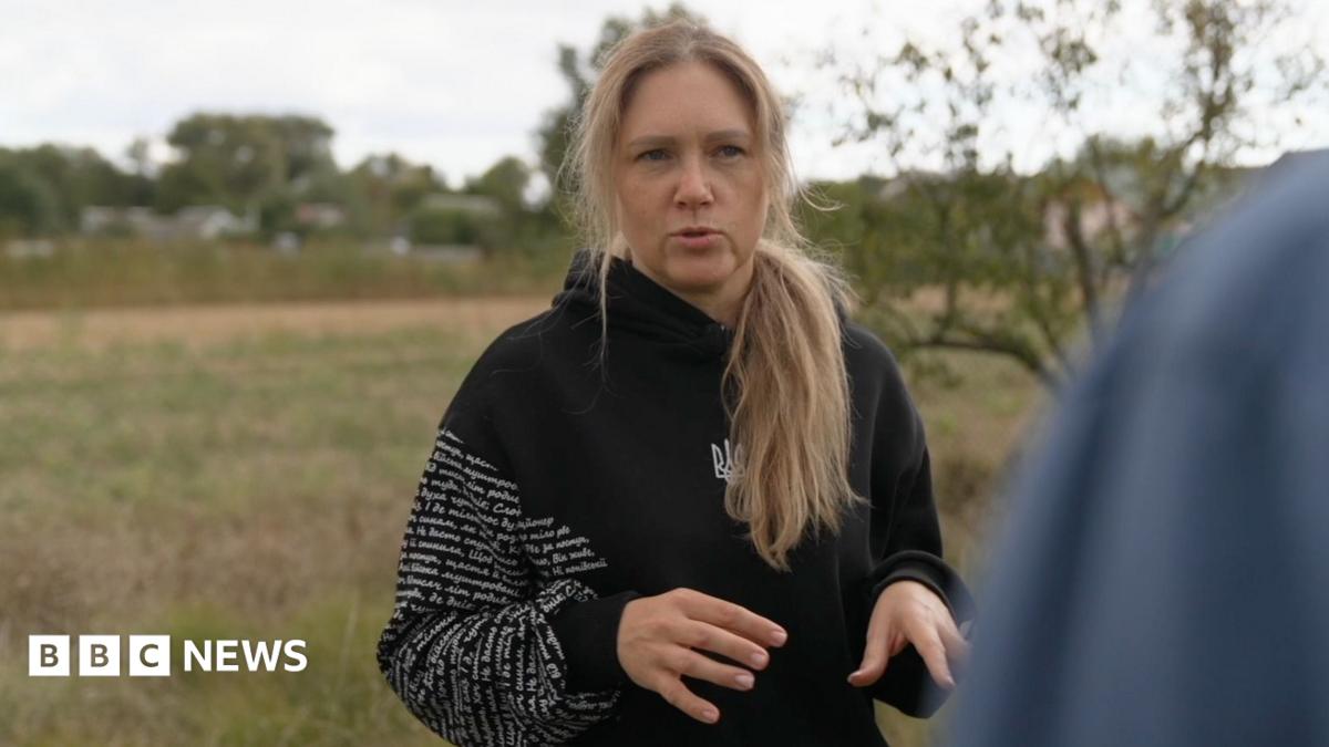 Olena standing in the countryside